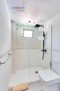 a bathroom with a glass shower stall and a toilet at Vivienda Vacacional Casa Evy in Puerto del Carmen
