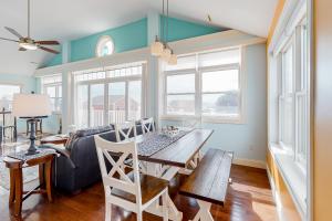 a dining room with a table and a couch at Hampton Beach Beauty in Hampton