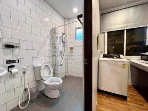 a white bathroom with a toilet and a sink at Mini-ME Home, A Cozy Entire House in Old City in Chiang Mai +83 photos