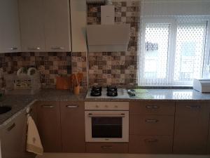a kitchen with a stove top oven next to a window at Family Apart-Hotel 2022 - 6 in Antalya