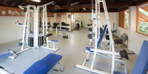 a gym with blue chairs and machines in a room at Muriel Le Mar Estang in Canet-en-Roussillon