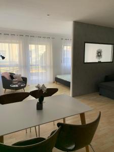 a living room with a white table and chairs at Appartement by Luis in Burgheim