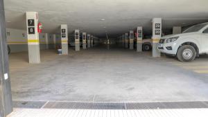 a parking lot with cars parked in a parking garage at Apart France - Con Gim, Piscina y estacionamiento - Matrimonial in Río Cuarto