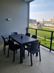 a black table and chairs on a balcony at Sue Beacon Rock in Durban