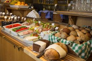 a buffet with bread and vegetables and other foods at Crystal Plaza Hotel in Stockholm