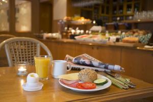 a table with a plate of food and a breakfast of eggs and fruit at Crystal Plaza Hotel in Stockholm