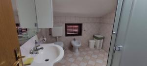 a bathroom with a sink and a toilet at Apartma Ivan in Portorož +32 photos