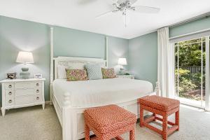 a bedroom with a white bed and a window at 13 Green Winged Teal in Fernandina Beach