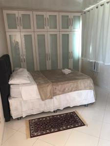 a bedroom with a large bed and a rug at Hotel Pousada Irmaos Freyhardt in Rio de Janeiro