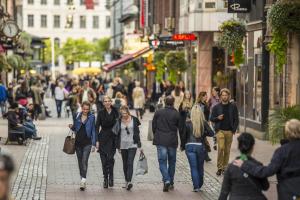a group of people walking down a busy city street at Crystal Plaza Hotel in Stockholm