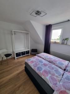 a bedroom with a large bed and a window at Ferienwohnung bei Natie in Brilon