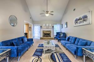a living room with blue couches and a fireplace at Covington Abode Less Than 30 Mi to Stone Mtn Park! in Covington
