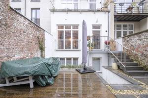 a house with a tent on the side of it at Magnificent 2 bedroom duplex + terrace Ixelles in Brussels