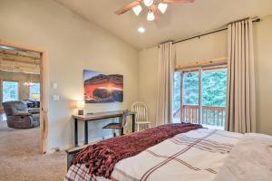 a bedroom with a bed and a desk and a window at All-Encompassing Cabin with Fire Pit and Kayaks! in Duck Creek Village