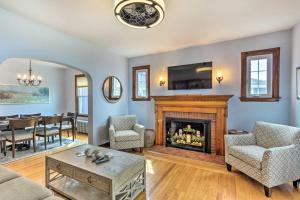 a living room with a fireplace and a dining room at Walkable New Haven Retreat with Ocean Views! in New Haven