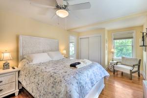 a bedroom with a bed with a ceiling fan and a chair at Walkable New Haven Retreat with Ocean Views! in New Haven