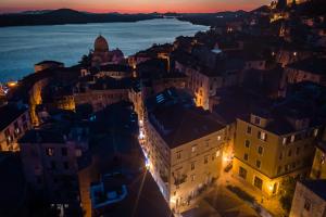 an aerial view of a city at night at Heritage Hotel Life Palace in Šibenik