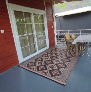 a patio with a table and chairs on a porch at Cıralı müstakil apart in Kemer