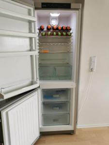 an open refrigerator with apples on top of it at Ferienwohnung am Kirchfeld in Rotthalmünster