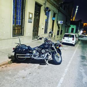 a motorcycle parked on the side of a street at Montevideo Port Hostel in Montevideo