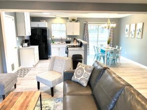 a living room with a couch and a kitchen at The Great Escape With Friends & Family & Pets!!! in Jacksonville