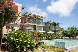 ein Gebäude mit Swimmingpool neben einem Ferienresort in der Unterkunft Miragem Noronha in Fernando de Noronha