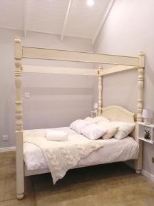 a bedroom with a bed with a white bed frame at Cooper Cottage in Howick