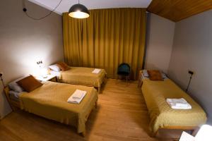 a room with two beds and a table with a chair at Ozon Gudauri in Gudauri