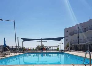 a swimming pool in front of a building at Panoramic Holidays - Standard 73 in Peyia