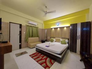 Ένα ή περισσότερα κρεβάτια σε δωμάτιο στο Hindusthan Inn - On Beach