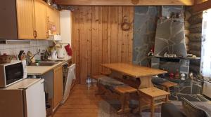 a kitchen with a table and a sink in it at Kelomökki Sallatunturissa in Salla