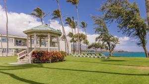 a gazebo on the lawn in front of a house at Maui Beach Hotel in Kahului