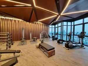 a gym with exercise equipment in a room with windows at Downtown Chic Condo Rooftop Pool #EN797 in Pattaya Central