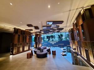 a large room with a couch and chairs in a building at Downtown Chic Condo Rooftop Pool #EN797 in Pattaya Central