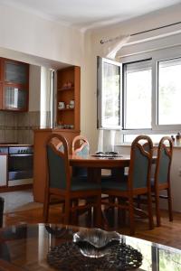 a kitchen with a dining room table and chairs at Apartment Music-center, in the center of Podgorica in Podgorica