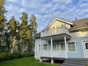 a house with a balcony on the side of it at Pan Golf & Spa Villas in Imatra