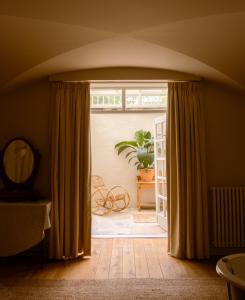 a room with a door open to a patio with a plant at Boath House Hotel in Nairn