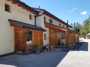 a house with wooden buildings with a lot of plants at Enzian 176 Al , Wohnung C3 in Tiefencastel