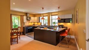 a kitchen with a large island in the middle at Finest Retreats - The Old Post Office Apartment 3 in Buxton +15 photos