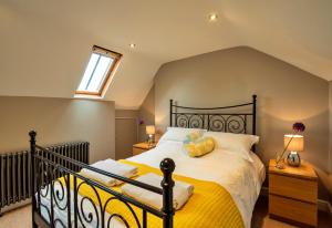 a bedroom with a black bed with yellow sheets at Finest Retreats - The Old Post Office Apartment 3 in Buxton