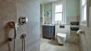 a bathroom with a toilet and a sink at Finest Retreats - The Old Post Office Apartment 3 in Buxton