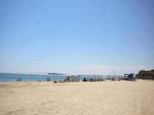 a group of people on a beach with the ocean at Apartamentos Colibri in Cambrils