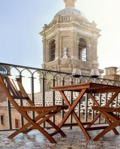 uma cadeira de madeira sentada em frente a um edifício em Apartamento con vistas en centro histórico em Zaragoza