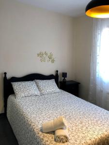 Un dormitorio con una cama con una manta encima. en La Duquesa del Valle, en Cabezuela del Valle