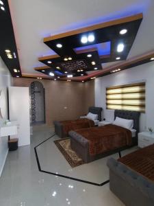 a bedroom with two beds and a tv on the ceiling at Petra paradise home in Wadi Musa