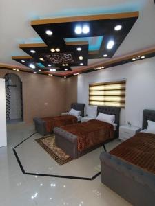 a bedroom with two beds and a couch in it at Petra paradise home in Wadi Musa