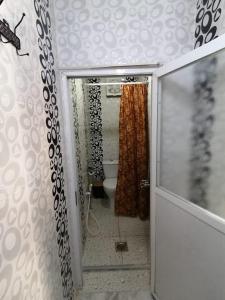 a bathroom with a toilet and a shower curtain at Petra paradise home in Wadi Musa