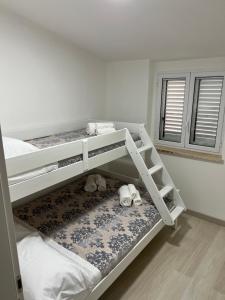 a bedroom with two bunk beds with stuffed animals on the floor at Residence Borghi in Scalea
