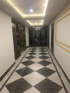 a hallway with a checkered floor in a building at Tourist rent Apartment in Istanbul