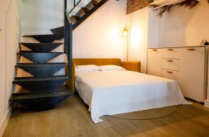 ein Schlafzimmer mit einem Bett und einer Wendeltreppe in der Unterkunft Calle Amparo 86 Lujoso Dúplex con Jacuzzi en Lavapies especial parejas in Madrid